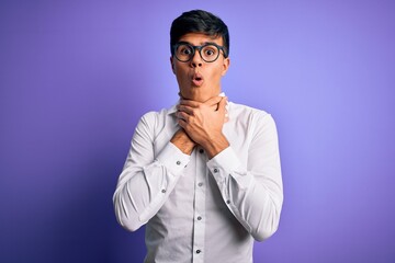 Sticker - Young handsome business man wearing shirt and glasses over isolated purple background shouting and suffocate because painful strangle. Health problem. Asphyxiate and suicide concept.