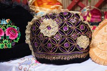 Closeup Shot Of Black Velvet Female Hat With Purple And Yellow Beads