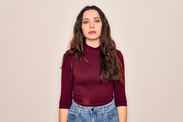 Wall Mural - Young beautiful woman wearing casual t-shirt standing over isolated white background with serious expression on face. Simple and natural looking at the camera.