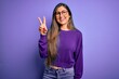 © Krakenimages.com - Young beautiful smart woman wearing glasses over purple isolated background showing and pointing up with fingers number two while smiling confident and happy.