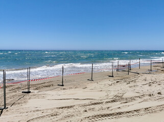 beach with construction net, access to the beach is prohibited