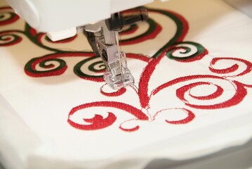 Canvas Print - Closeup shot of an embroidery machine sewing a pattern on fabric