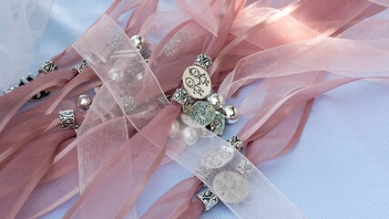 Sticker - Closeup shot of pink ribbons with different silver charms