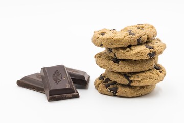 Wall Mural - Closeup shot of dark chocolate pieces and stacked cookies isolated on a white background