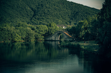 Poster - There is a bridge in the middle of the calm lake