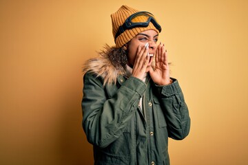 Sticker - Young african american afro skier girl wearing snow sportswear and ski goggles Shouting angry out loud with hands over mouth