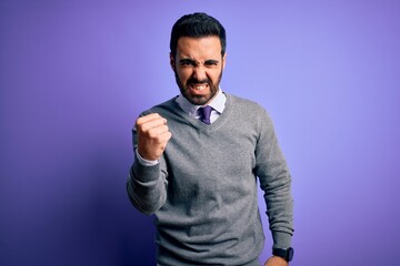 Poster - Handsome businessman with beard wearing casual tie standing over purple background angry and mad raising fist frustrated and furious while shouting with anger. Rage and aggressive concept.