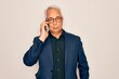 © Krakenimages.com - Middle age senior grey-haired business man wearing glasses talking on smartphone with a confident expression on smart face thinking serious