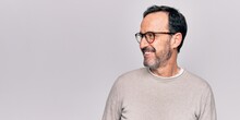 Middle Age Handsome Man Wearing Casual Sweater And Glasses Over Isolated White Background Looking To Side, Relax Profile Pose With Natural Face And Confident Smile.