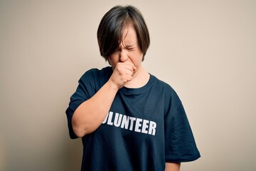 Canvas Print - Young down syndrome volunteer woman wearing social care charity t-shirt feeling unwell and coughing as symptom for cold or bronchitis. Health care concept.