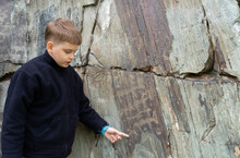 Ancient Cave Paintings And Little Boy. Bronze Age Culture Dated To The First Half Of The 2nd Millennium BC.	