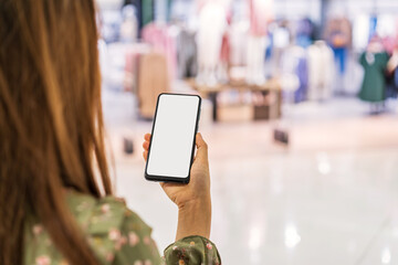 Wall Mural - Young asian woman with shopping bags using smart phone and shopping at mall, Woman lifestyle concept