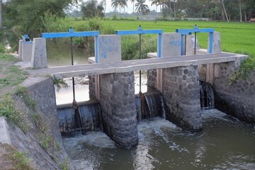 Canvas Print - Irrigation system on river banks to regulate the irrigation of residents' agriculture