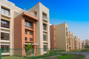 New residential building complex being built at Rajarhat New Town area of Kolkata, West Bengal, India. Kolkata is one of the fastest growing city in eastern region of India. Blue sky background.