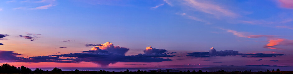 Wall Mural - bright sunlight through the clouds against a breathtaking evening sky at sunset. panorama, natural c