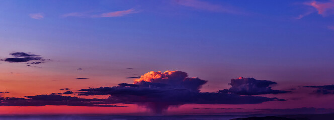 Wall Mural - bright sunlight through the clouds against a breathtaking evening sky at sunset. panorama, natural c