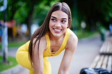 Young sporty woman resting on running track. Beautiful woman in sportswear