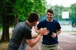 © JustLife - Young men training on a race track. Two young friends running on athletics track
