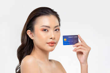 Wall Mural - Youthful skin Asian woman showing credit card isolated on white background for beauty treatment promotion and installment payment concepts