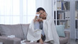 © PRPicturesProduction - asian female patient staying at home with conoravirus covered in blanket and holding tissue is feeling chill and can’t stop coughing. korean woman with infection touching sore throat and head hurts