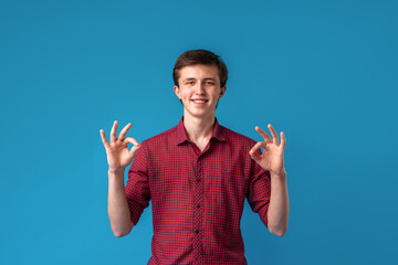 Happy happy guy shows OK gesture with both hands.