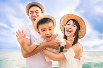 Wall Mural - Happy family  Having Fun Playing on the Beach