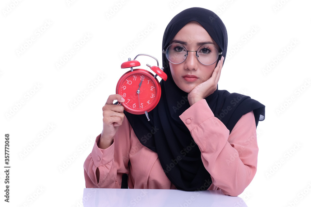 Muslim woman hold alarm clock with deference expression face with ...