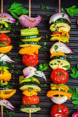 Wall Mural - Grilled vegetable skewers in grill pan, top view. Vegan food concept.