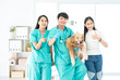 © Thirawatana - Vet and owner showing thumbs up. Owner and veterinary holding cute Golden Retriever dog showing like.