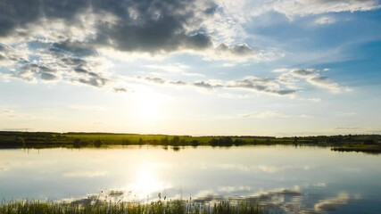 Wall Mural - Timelapse of white clouds over the lake in good summer weather