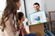 © Syda Productions - mortgage, family and real estate concept - happy mother, father and little daughter with stuff in boxes moving to new home