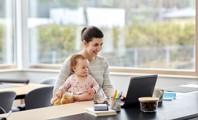 remote job, multi-tasking and family concept - happy smiling mother with baby and laptop working at 