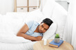 © Syda Productions - people, bedtime and rest concept - indian man sleeping in bed at home