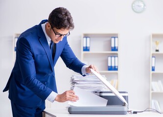 Businessman making copies in copying machine