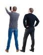 © ghoststone - Back view of two man in sweater with mobile phone.