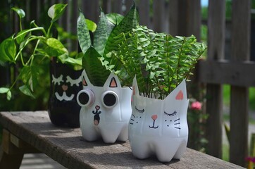 Recycled colored flower pots made of used plastic bottles. Nice decoration for inside and outside.