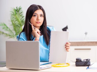 Young beautiful female doctor working in the clinic