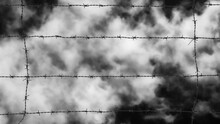 Imprisoned Concept. Barbed Wire Strands With Azure Sky And White Clouds As Background