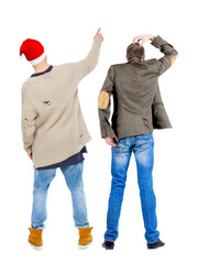 Canvas Print - Back view of two man in sweater pointing.