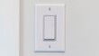 Panorama crop Electrical rocker light switch with flat broad lever on white interior wall