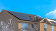 Panorama Home along Wasatch Mountain terrain with solar panels on the pitched roof