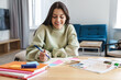© Drobot Dean - Photo of cheerful beautiful student woman smiling while doing homework