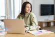 © Drobot Dean - Photo of cheerful student woman using laptop while doing homework