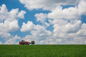 Wall Mural - Red tractor transporting straw bales