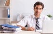 © Elnur - Young handsome businessman working in office