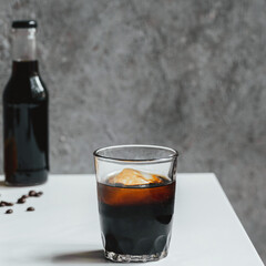 Wall Mural - selective focus of cold brew coffee with ice in glass on white table