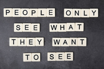 A motivational phrase People only see what they want to see formed with tiles