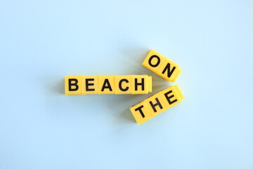 on the beach concept, inscription in yellow letters on a blue background