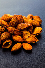 Canvas Print - Close up shelled almonds on grey surface