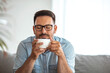 © Dragana Gordic - Shot of a handsome young man drinking coffee at home. Portrait of a happy man drinking a cup of coffee at home - lifestyle. I always start my day with a fresh cup of coffee